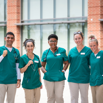 nursing students standing in front of Peterson Hall